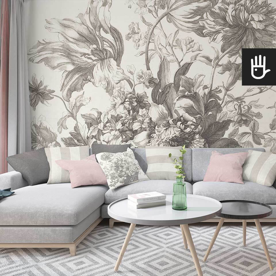 Salon z szarą narożną kanapą na tle kwiatowej tapety