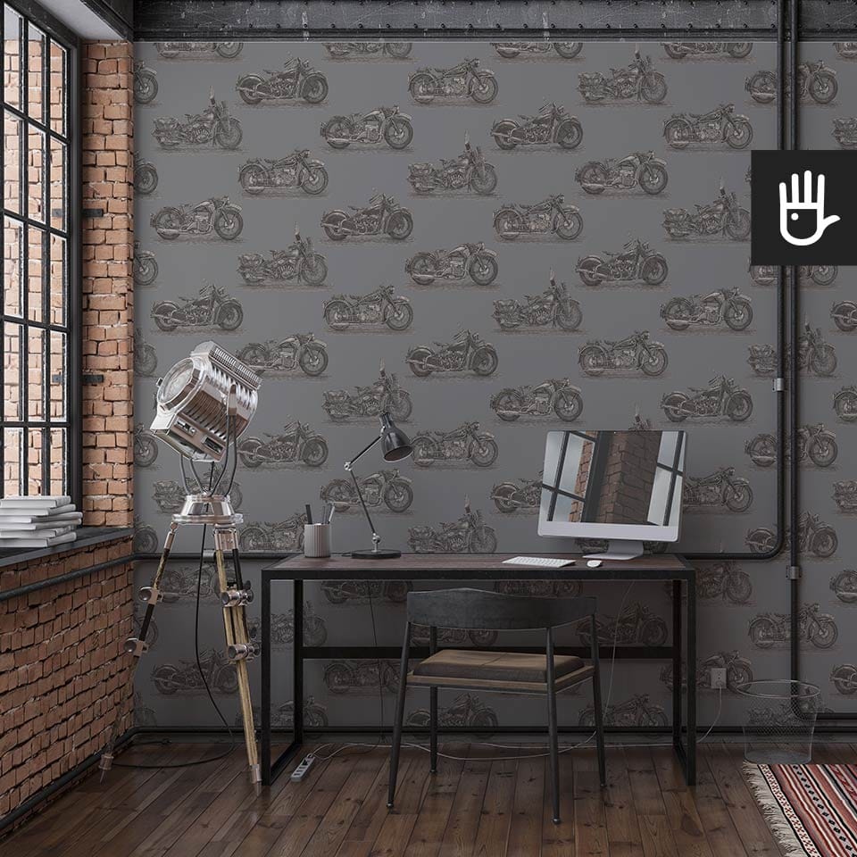 Loft z pracownią w stylu industrialnym z dekoracją ścienną, którą jest tapeta stare motocykle - ołów