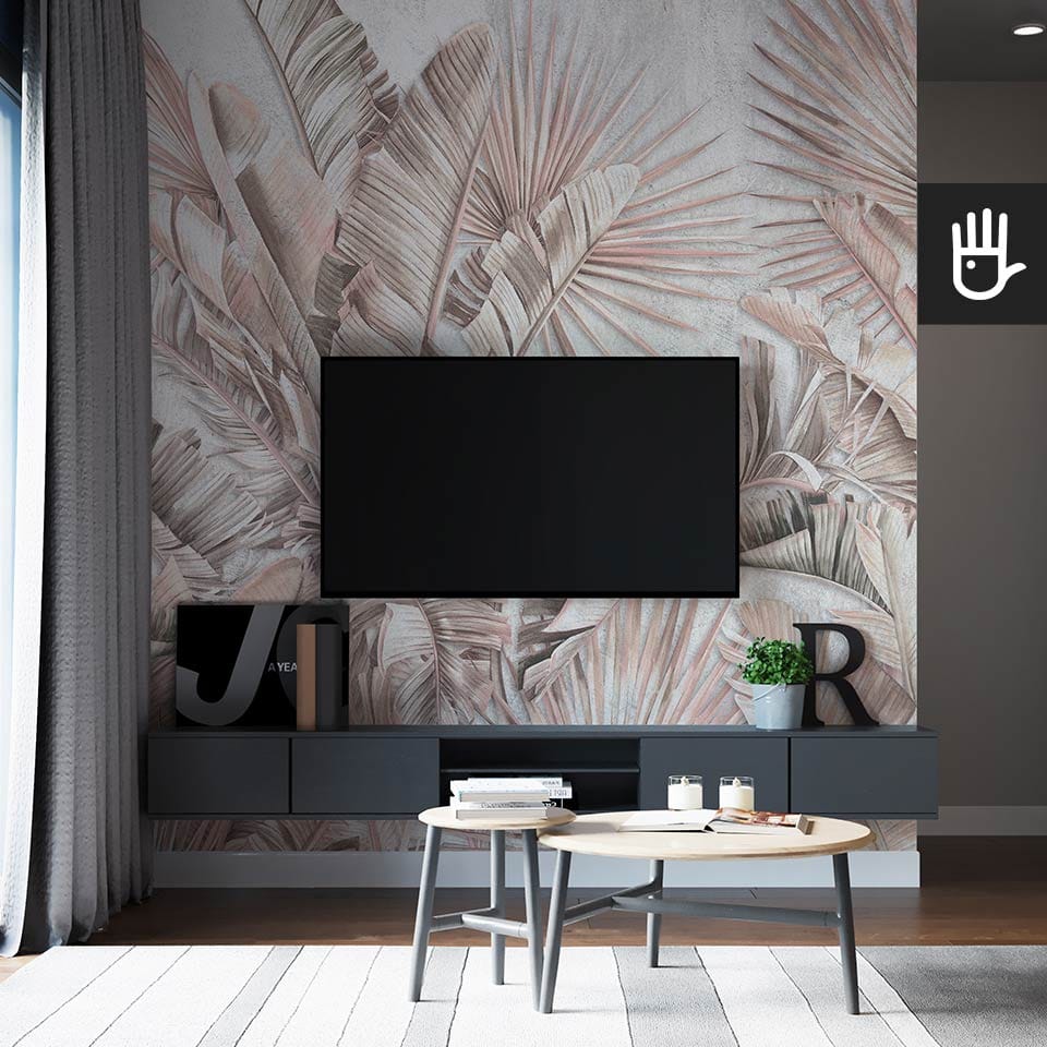 Nowoczesny salon z czarną podwieszaną szafką rtv z różnymi dekoracjami i stolikami kawowymi z drewna na tle fototapety pastelowa dżungla