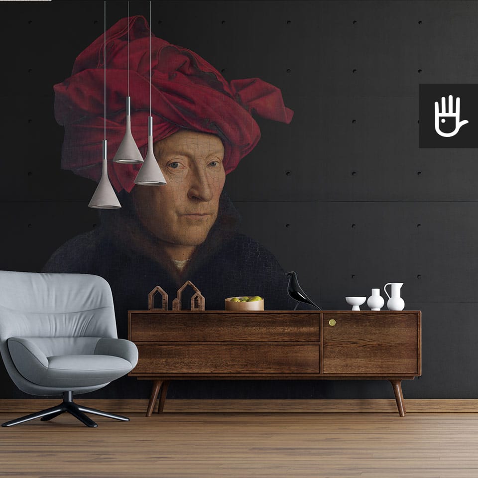 Skórzany fotel do czytania obok drewnianej szafki z książkami z dekoracyjnymi lampami wiszącymi na tle fototapety mężczyzna w turbanie
