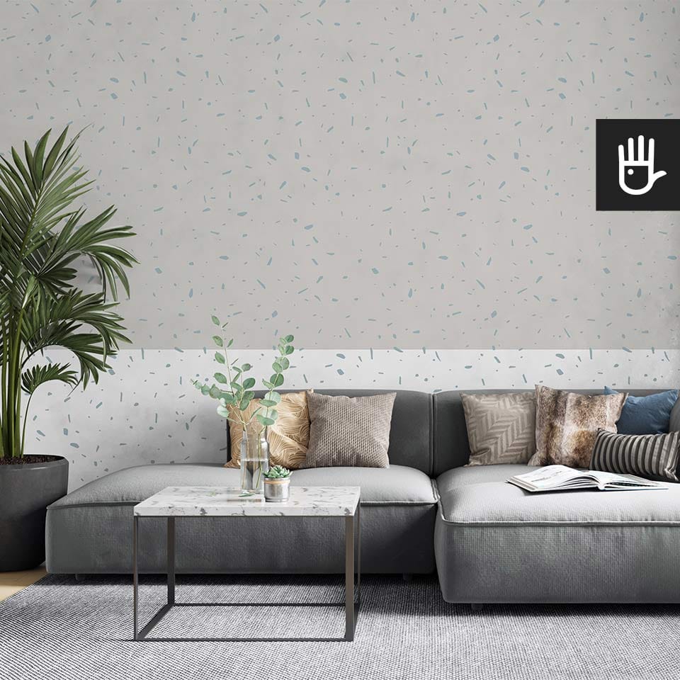 Nowoczesny salon z dużą szarą kanapą i stolikiem z imitacji kamienia na tle fototapety lody pistacjowe