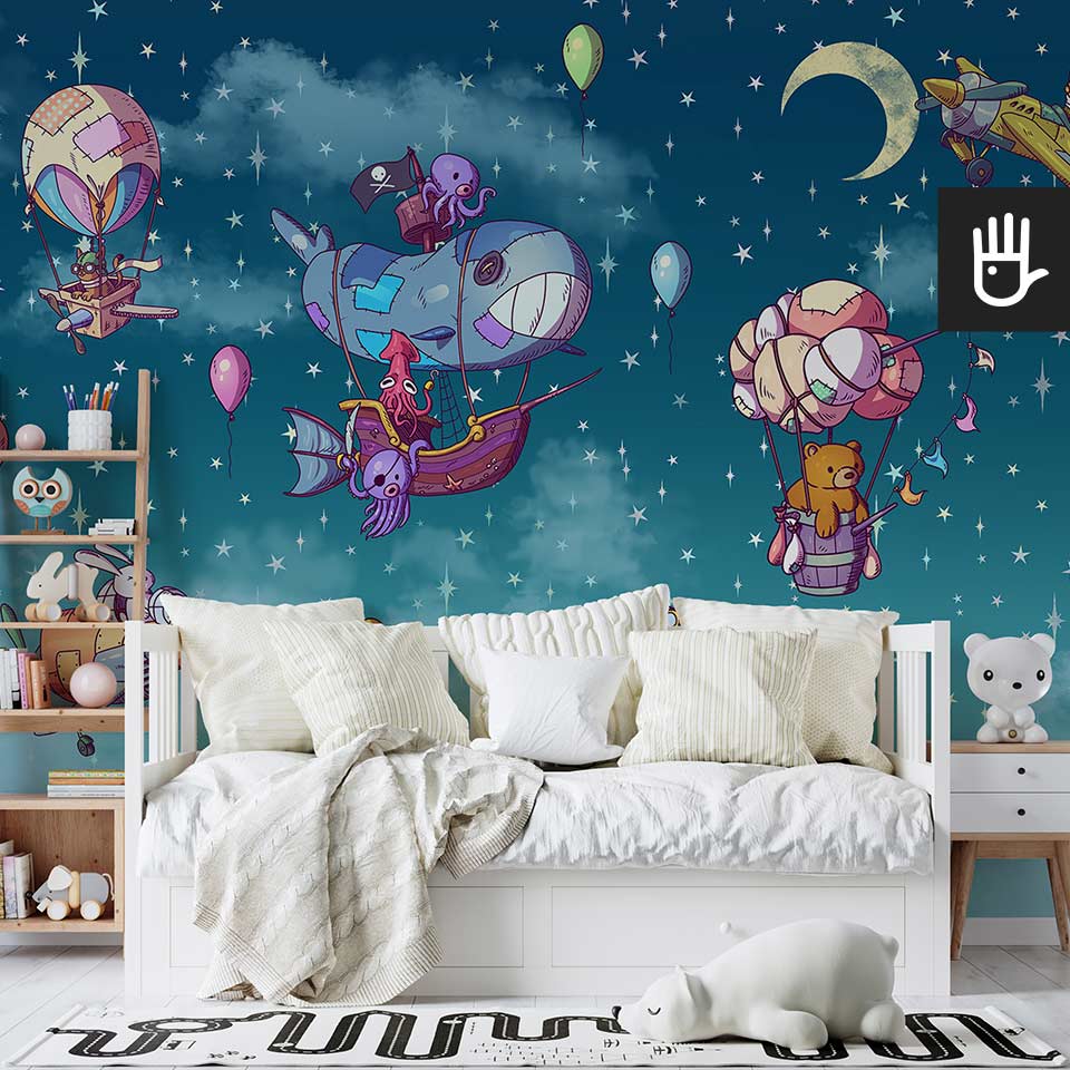 Przytulna sypialnia dziecięca z białym łóżkiem i drewnianym regałem na książki na tle fototapety w balony i gwiazdy w bajkowym stylu