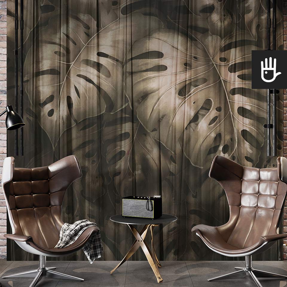 Loftowe studio ze skórzanymi fotelami i ceglaną ścianą ozdobioną fototapetą z wielkimi monsterami