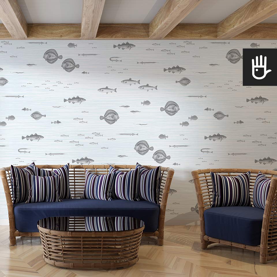 Przytulny salon z wiklinowymi meblami i granatowymi dodatkami na tle fototapety bałtyckie ryby