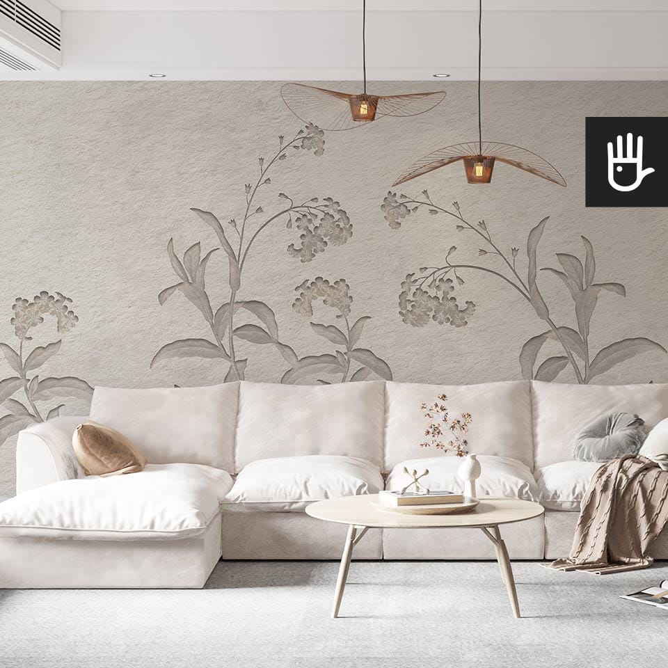 Jasny przytulny salon z beżową kanapą i jasnym stolikiem kawowym, urządzony w stylu boho na tle fototapety w szare niezapominajki