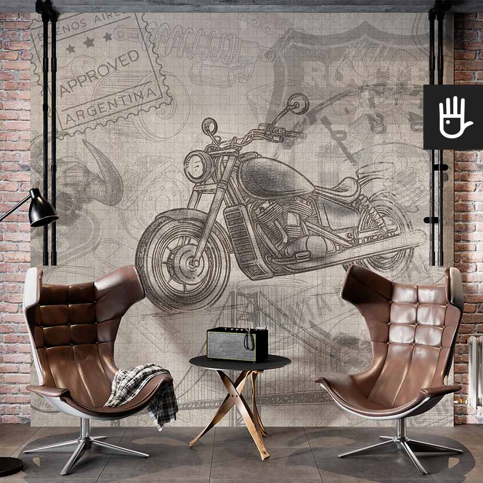 Studio ze skórzanymi fotelami na tle dekoracyjnej ściany z cegły i tapety z wzorem motocykla w stylu amerykańskim